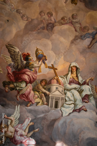 Painting of hooded woman with cross and crown on the domed ceiling of Charles Church in Vienna, Austria.