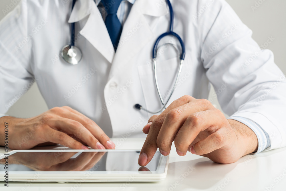 Close up of doctor hands using tablet computer Close up of doctor hands using tablet computer