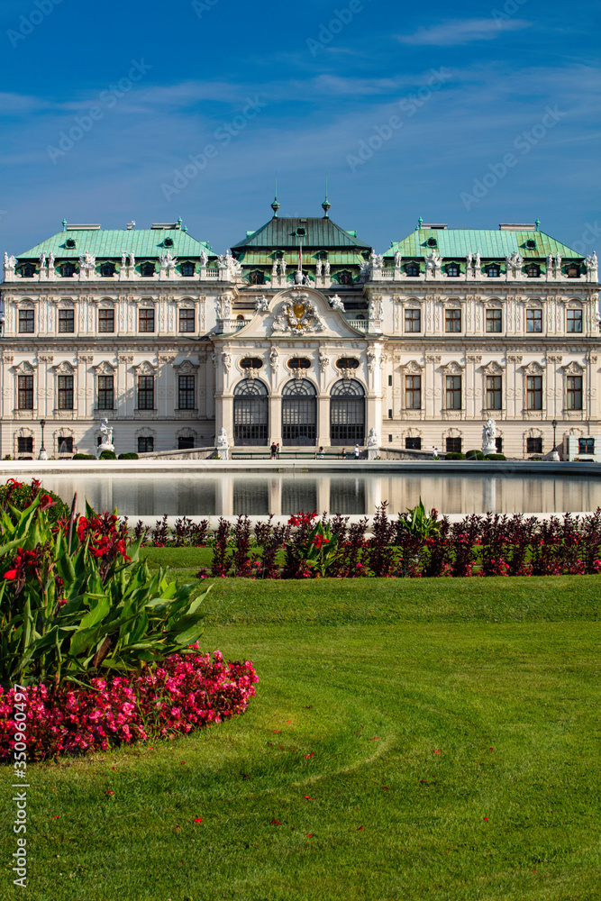 Flowers and a reflecting pool outside the front of the Belvedere Palace in Vienna, Austria