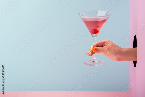 Woman's hand holding a glass of red prosecco
