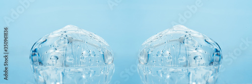 Texture of hyaluronic acid, serum gel, silicone implants, Transparent smear of gel on blue background photo