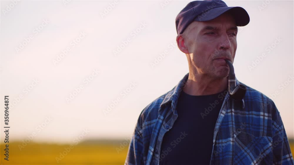 Contented Farmer Smoking His Pipe On Field Wile Examining Crops Agriculture. Contented Farmer Smoking His Pipe On Field Wile Examining Crops Agriculture.