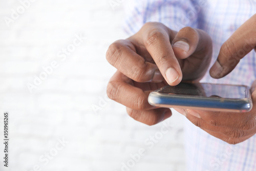 Close up of a man using mobile smart phone.