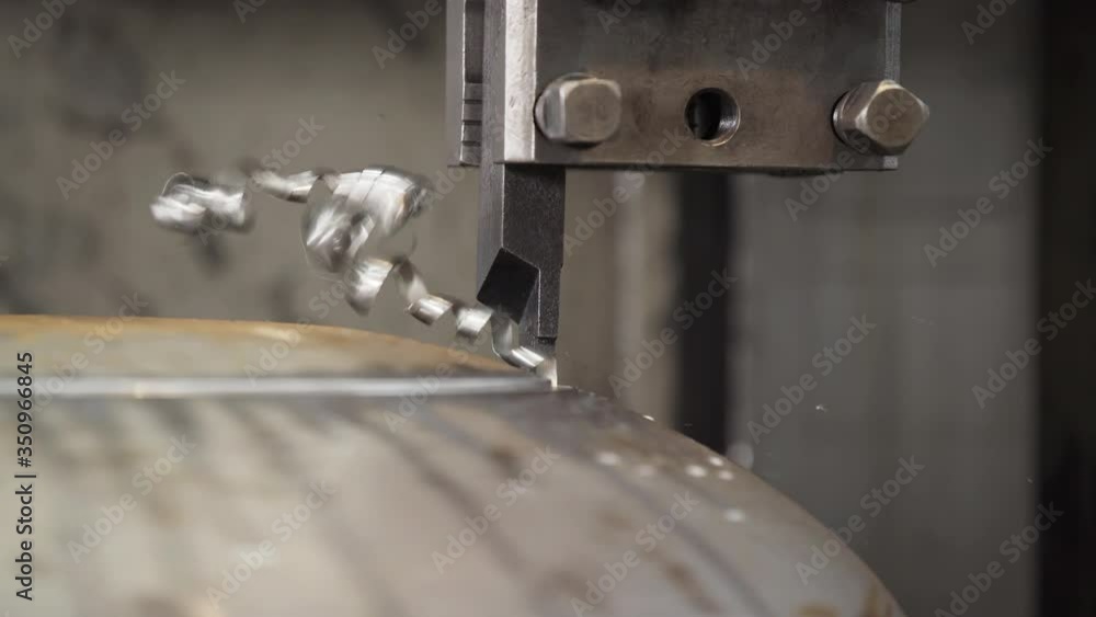 Cutter cuts metal workpiece. shavings twisted into spiral. Metal working milling machine. Produces metal detail in factory. Machine tools for metal working. Cutting metal modern processing technology Cutter cuts metal workpiece. shavings twisted into spiral. Metal working milling machine. Produces metal detail in factory. Machine tools for metal working. Cutting metal modern processing technology