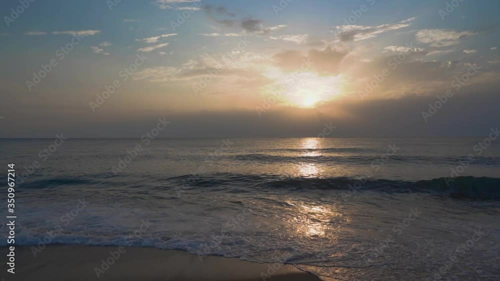 Beautiful sunset and waves lapping on the sandy beach. Beautiful sunset and waves lapping on the sandy beach.