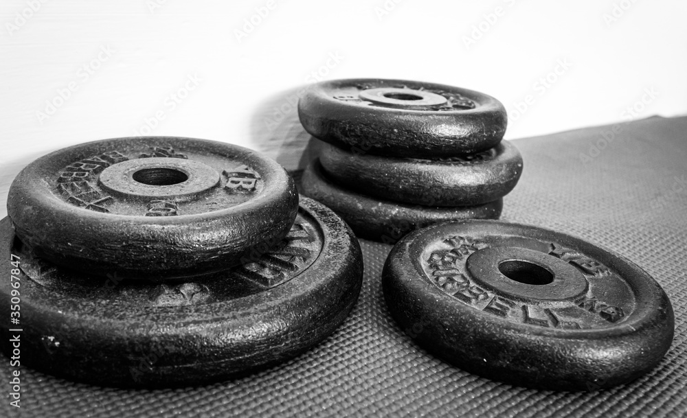 Close up of different sized weights on floor Close up of different sized weights on floor
