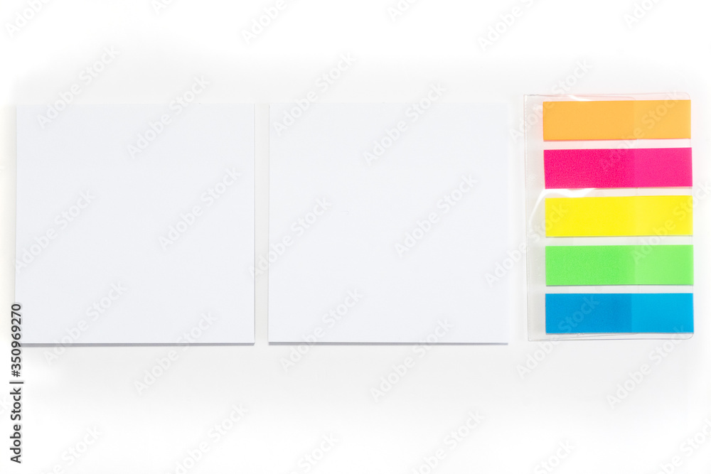 Two White sticky note and different colored sheets of note papers isolated on white background