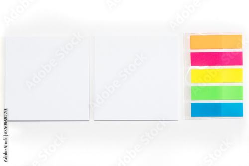 Two White sticky note and different colored sheets of note papers isolated on white background