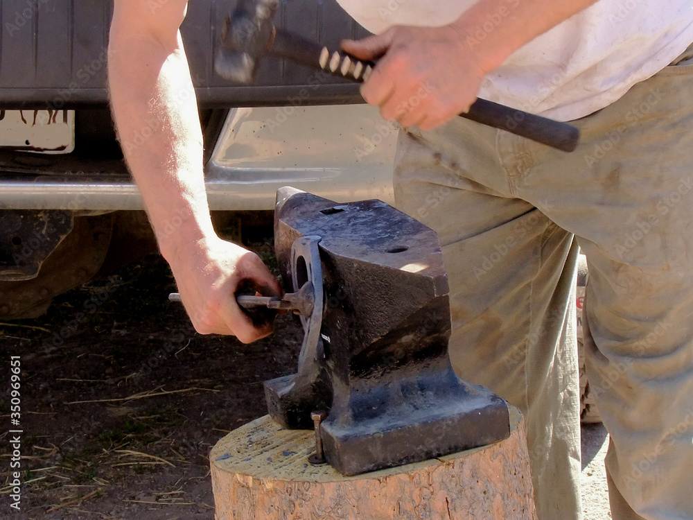 Farrier Work: Shaping a horseshoe on an anvil. Farrier Work: Shaping a horseshoe on an anvil.