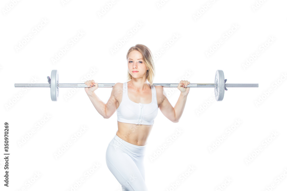 Obraz premium Beautiful athletic woman pumping up muscles with barbell on white background