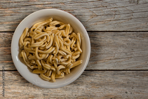Fresh italian pasta in a wooden background top view