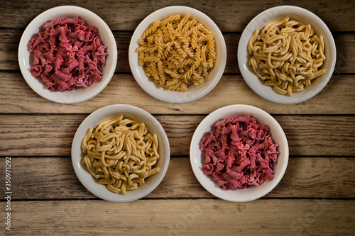 Fresh italian pasta in a wooden background top view