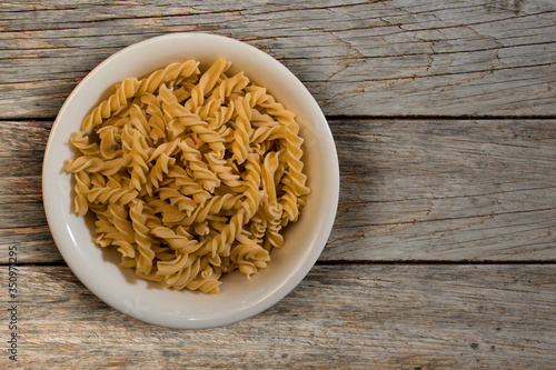 Fresh italian pasta in a wooden background top view