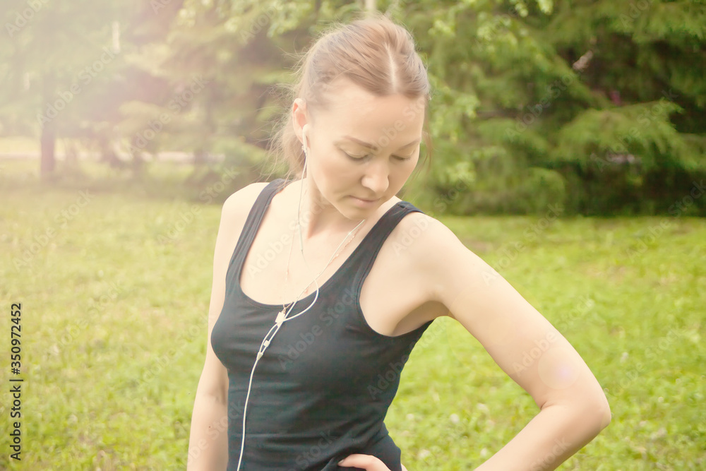 Active sporty woman relaxing after training outdoors.