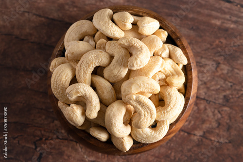 Bowl of Raw Natural Cashews on a Wooden Table