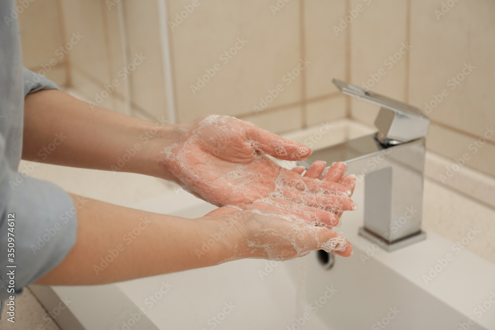 Woman washing hands with antiseptic soap in bathroom, closeup. Virus prevention Woman washing hands with antiseptic soap in bathroom, closeup. Virus prevention