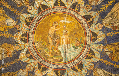 RAVENNA, ITALY - JANUARY 28, 2020: The ceiling symbolic mosaic with Baptism of Christ in the center among the apostles in Baptistery of Neon (Battistero Neoniano from 5. cent.