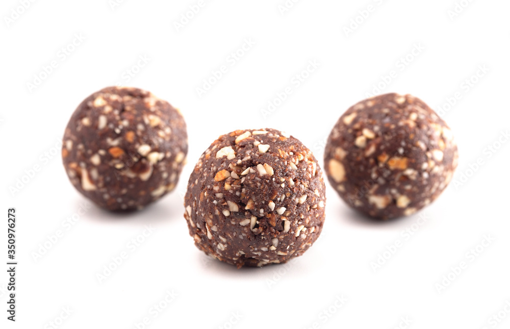 Chocolate Energy Protien Balls Made of Raw Organic Nuts and Dates on a White Background Chocolate Energy Protien Balls Made of Raw Organic Nuts and Dates on a White Background