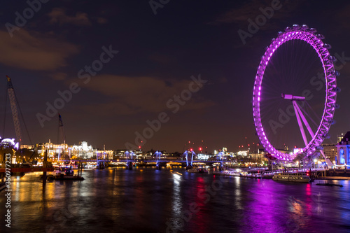 Night photo of London with illuminated London Eye and Thames