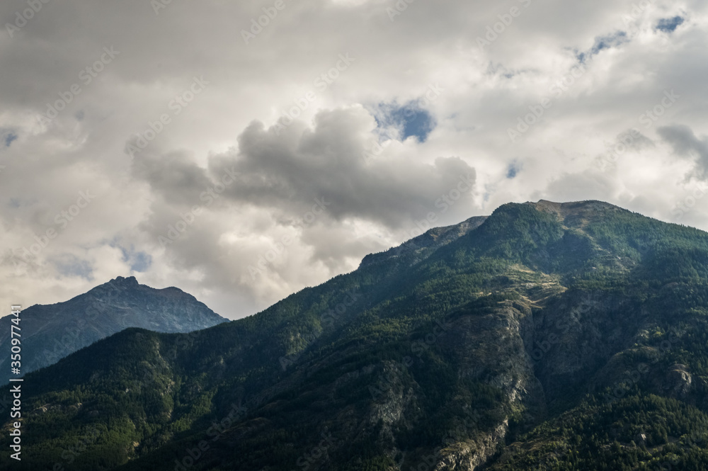 Italian Alps mountains in a cloudy september day, seen from Courmayeur area, Aosta Valley, Italy.