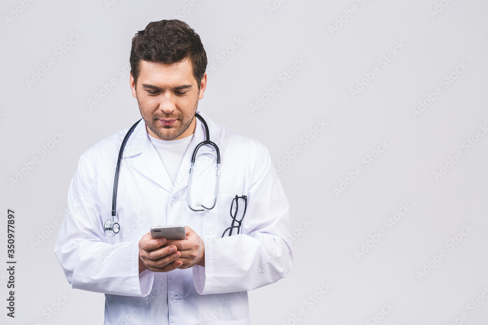 Male doctor hands using mobile phone, hands with mobile phone. Male doctor in white coat is using a modern smartphone device isolated over white background. Male doctor hands using mobile phone, hands with mobile phone. Male doctor in white coat is using a modern smartphone device isolated over white background.