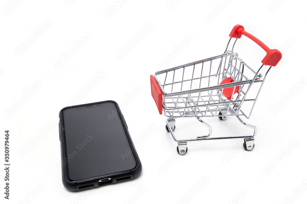 Empty trolley cart and mobile phone on a white background. Online shopping, sale, finance, and business concept. Empty trolley cart and mobile phone on a white background. Online shopping, sale, finance, and business concept.
