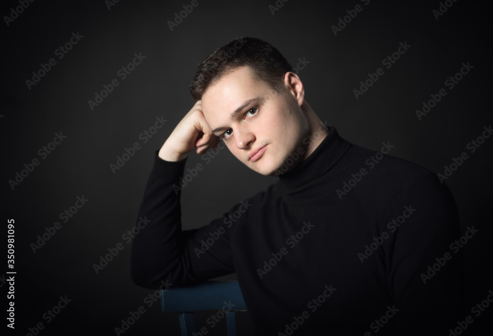 Portrait of an attractive man in the studio on a black background. Portrait of an attractive man in the studio on a black background.