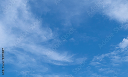 Beautiful white fluffy clouds on vivid blue sky in a sunny day