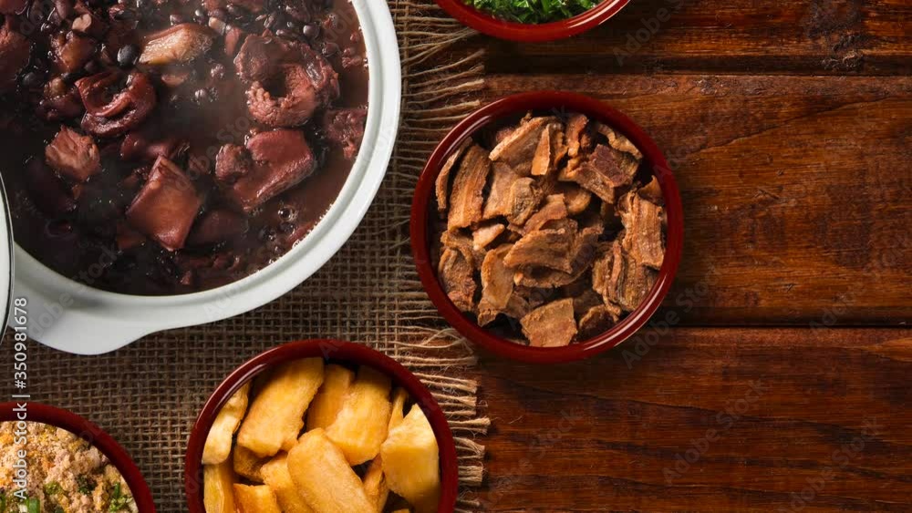 Slide shot Brazilian feijoada on the table with smoke. Top View Slide shot Brazilian feijoada on the table with smoke. Top View