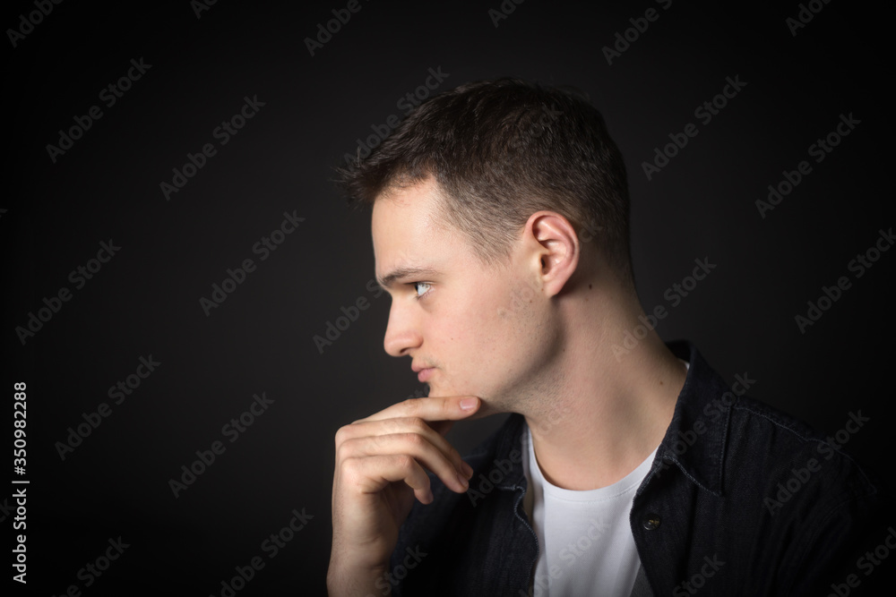 Portrait of an attractive man in the studio on a black background. Portrait of an attractive man in the studio on a black background.