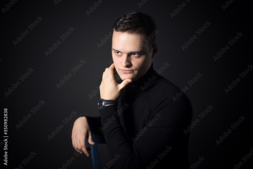 Portrait of an attractive man in the studio on a black background. Portrait of an attractive man in the studio on a black background.