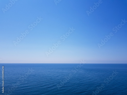 The sea and sky are bright blue. Skyline