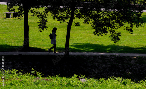 Single person silhouette walking in the "Pontido" village park, Povoa de Lanhoso, Portugal.