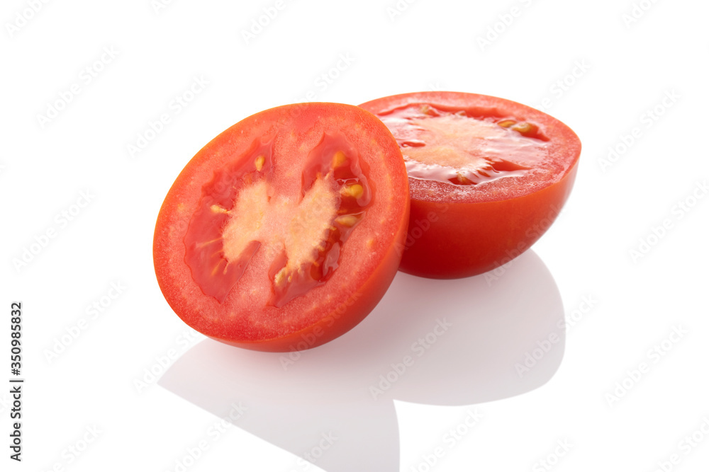 Sliced tomato. Two half tomatoes facing left on a white background.
Sliced tomato. Two half tomatoes facing left on a white background.