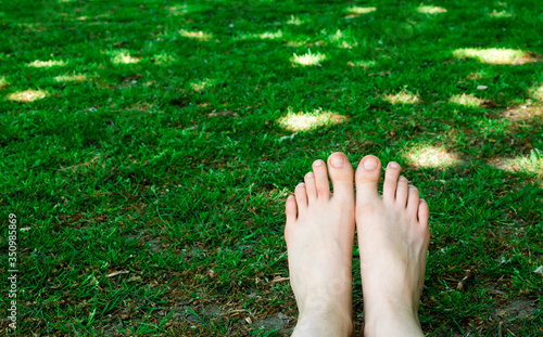 grounding, walking barefoot, female feet, barefoot, walking on green grass 