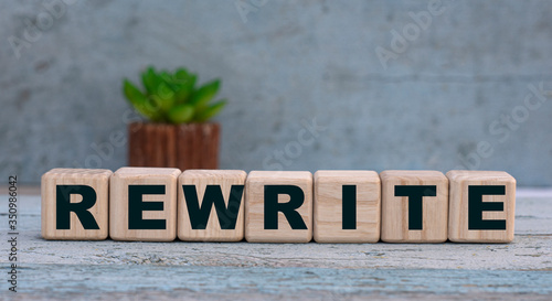 REWRITE word on cubes on an old gray background with cactus