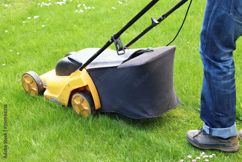 man mows grass with a lawn mower man mows grass with a lawn mower