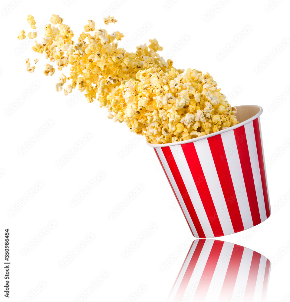 Flying popcorn from paper striped bucket isolated on white background Flying popcorn from paper striped bucket isolated on white background