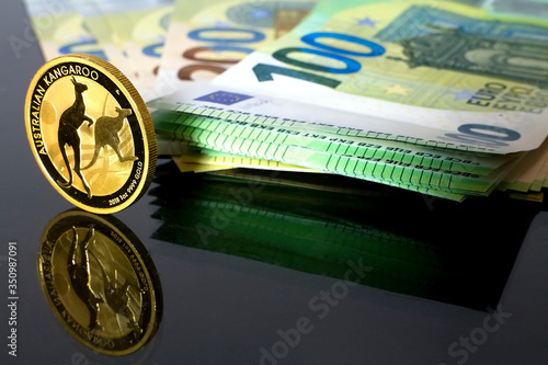 Australian Kangaroo - a gold coin placed on money valid in the European Union worth 100 euros. The Golden Age - Gold replace paper Money.