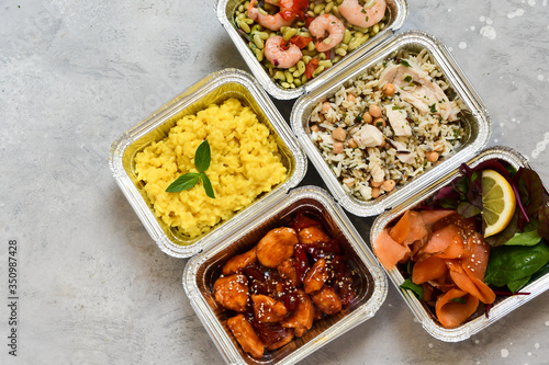 Different aluminium lunch box with healthy meals for lunch. Healthy food restaurant dish delivery. Take away fitness food. top view