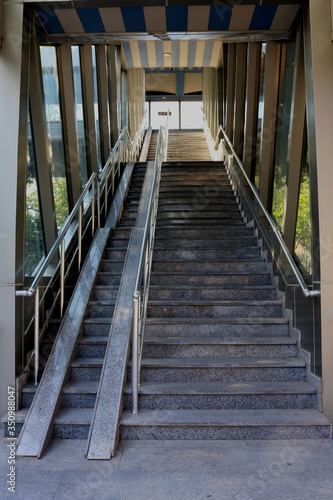 Stairs of pedestrian overpass. Image of footbridge. Indoor elevated pedestrian crossing