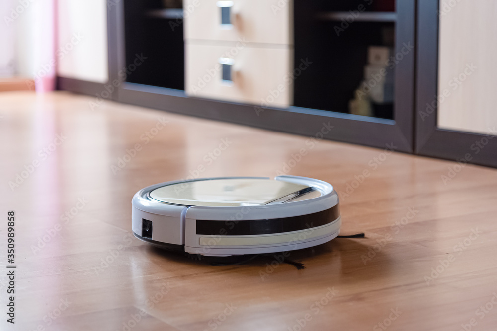 Robot vacuum cleaner cleans the floor in the living room Robot vacuum cleaner cleans the floor in the living room