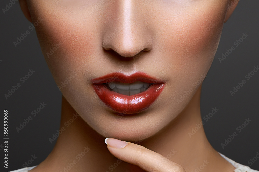 Close-up portrait of beautiful young woman lips with bright red lipstick Close-up portrait of beautiful young woman lips with bright red lipstick