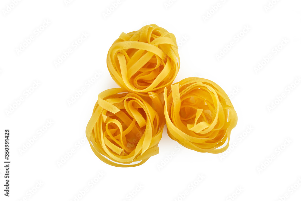 Italian raw dry pasta fettuccine isolated on white background Italian raw dry pasta fettuccine isolated on white background