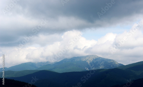 High mountains covered with clouds. Summer landscape.