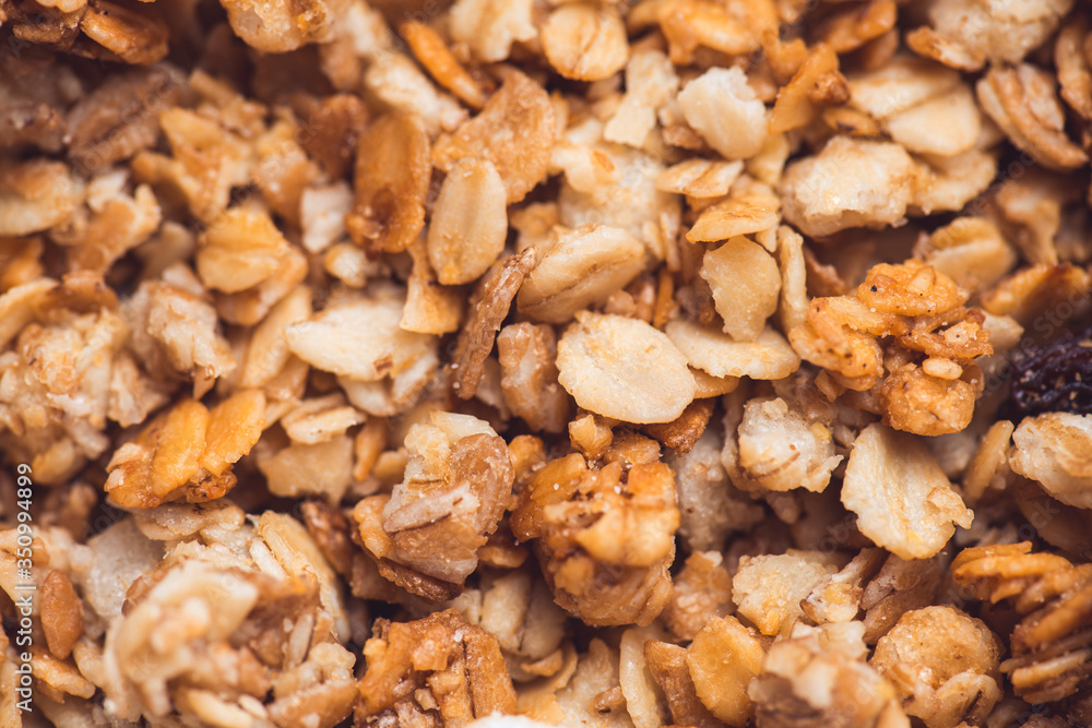Useful and tasty muesli with nuts, rasins and flakes. Selective focus macro shot with very shallow depth of field. Healthy and vegetarian lifestyle Useful and tasty muesli with nuts, rasins and flakes. Selective focus macro shot with very shallow depth of field. Healthy and vegetarian lifestyle