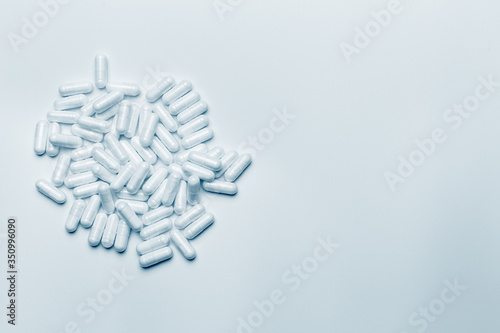 Pills on blue background with copy space, medical concept