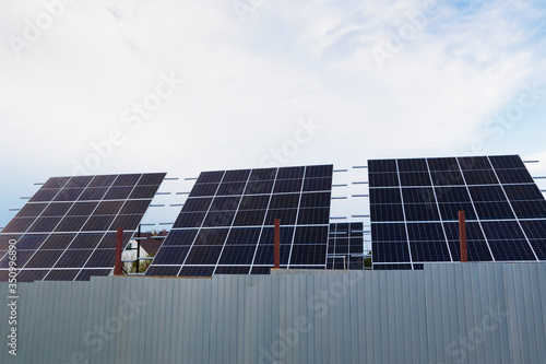 Solar panels or photovoltaic converters in a residential complex. photo