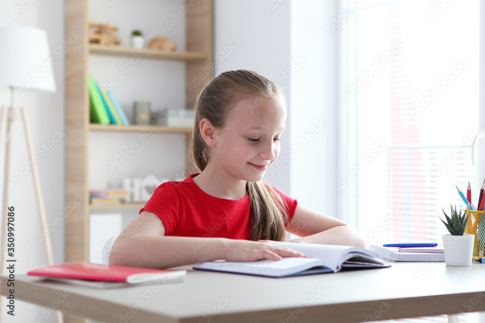 little girl reads a book at home
little girl reads a book at home