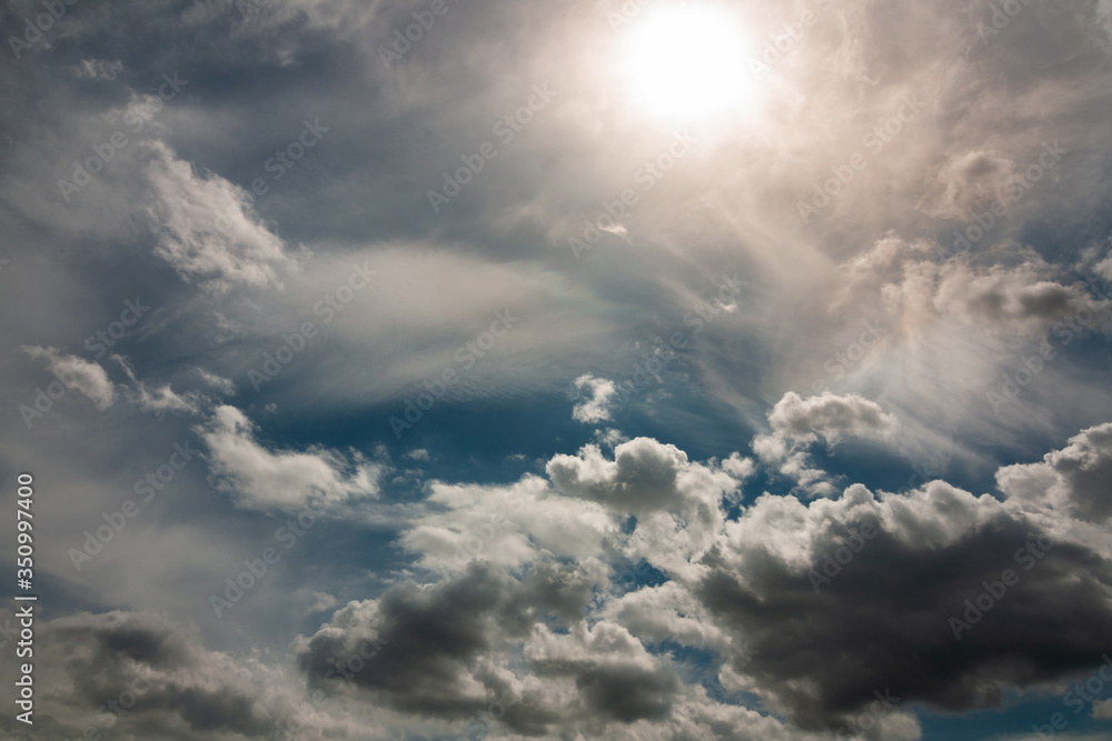 dramatic mystical contrasting sky with thick gray clouds below and the sun above in a haze. artistic image for the original background, layout or decor dramatic mystical contrasting sky with thick gray clouds below and the sun above in a haze. artistic image for the original background, layout or decor